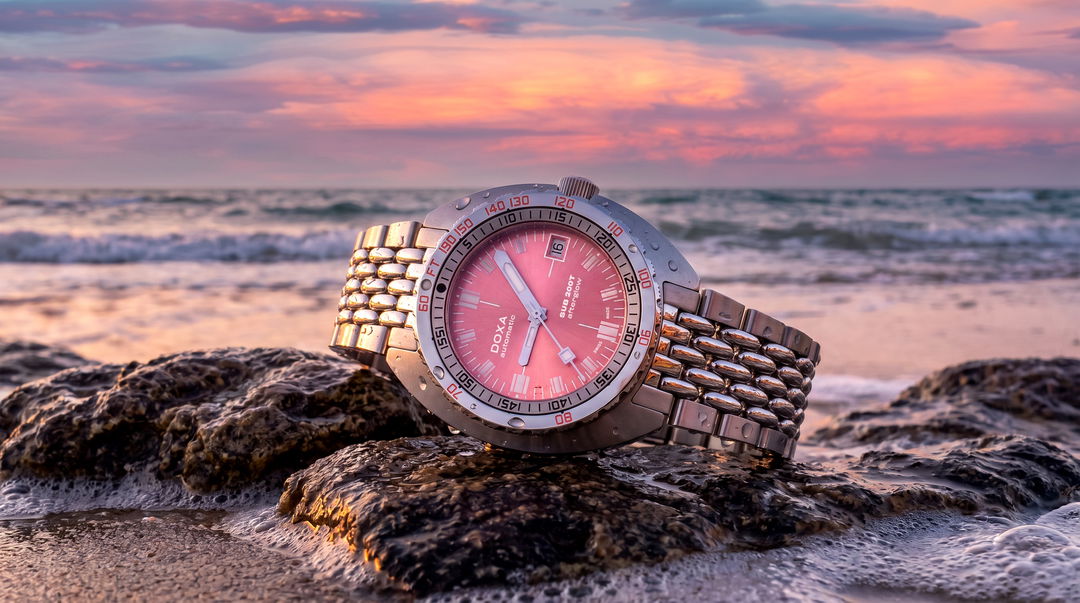 DOXA SUB 200T Afterglow photographed against a sunset-coloured background